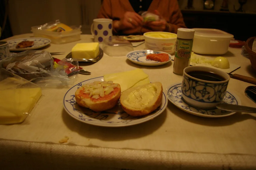 An evening bread spread with rolls, butter, cheese and Mettwurst.