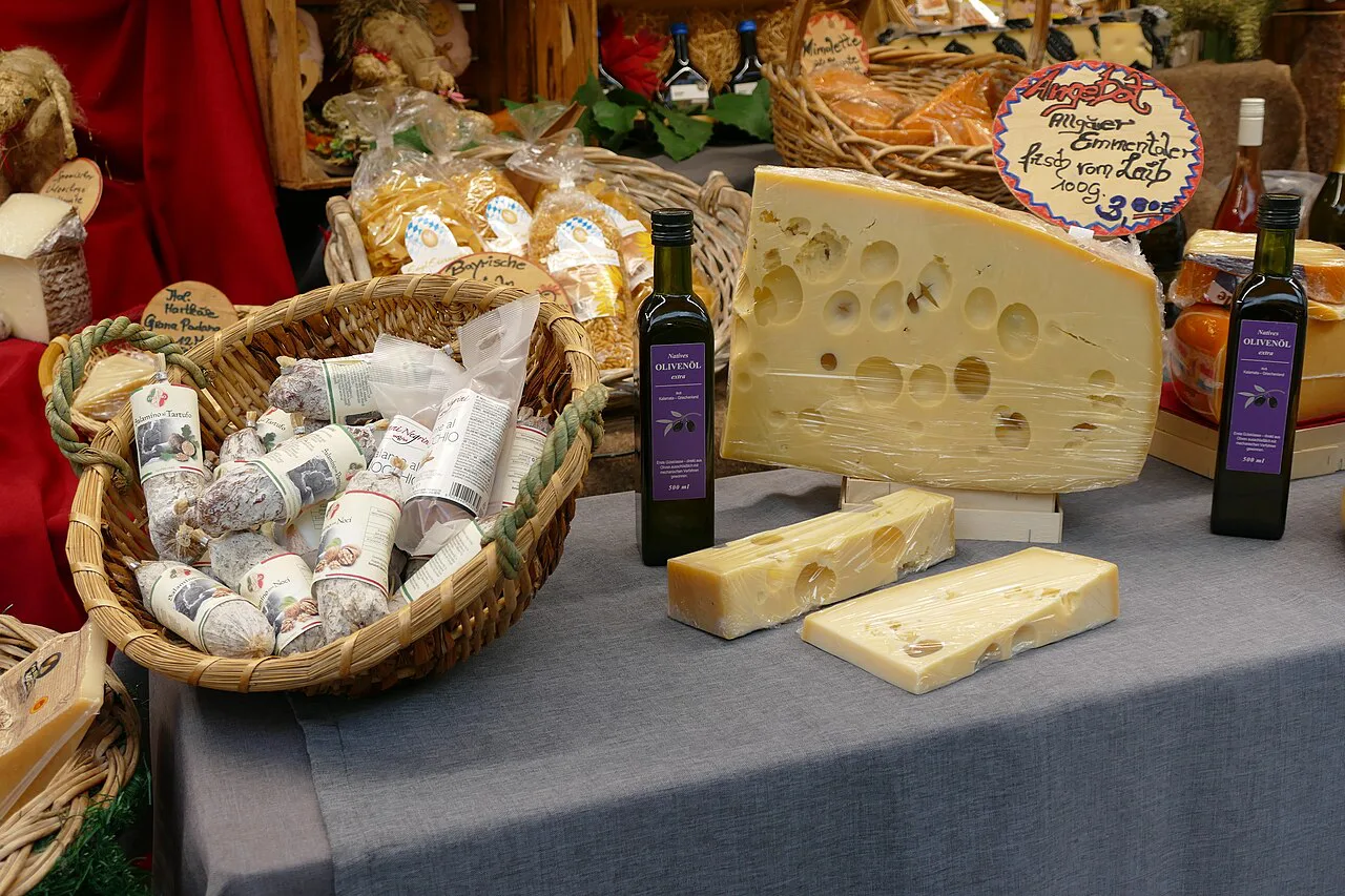 Emmental cheese and salami for sale at the Viktualienmarkt food market, Munich.