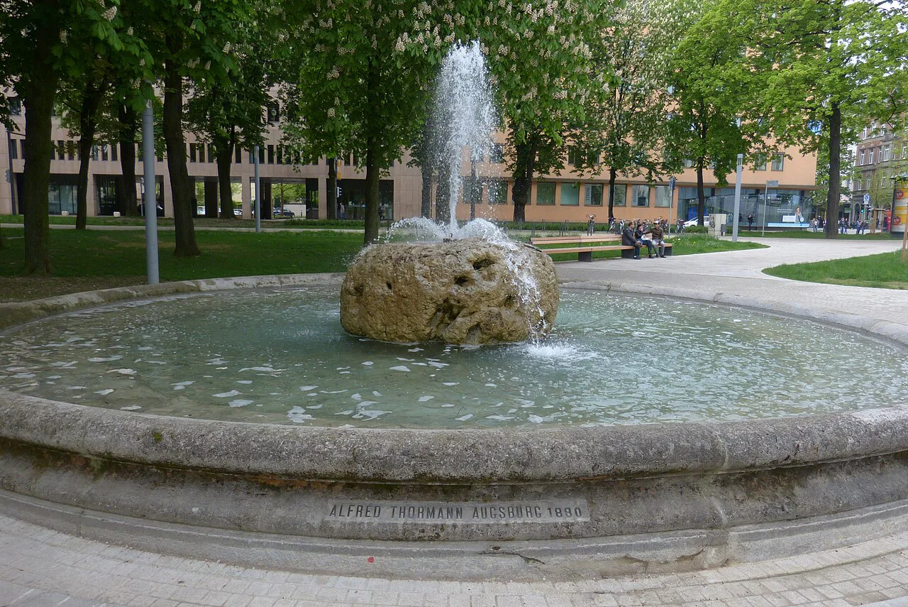 Thormann Fountain in a leafy square, Augsburg.