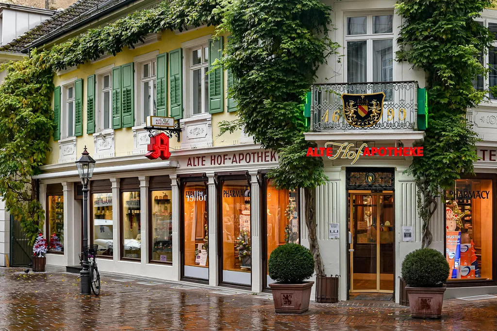 The ivy-covered Alte Hof-Apotheke building on a rainy street, Baden-Baden.