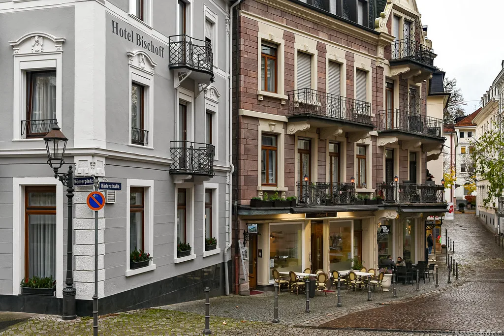 Café tables outside a hotel on a cobbled old-town street, Baden-Baden.