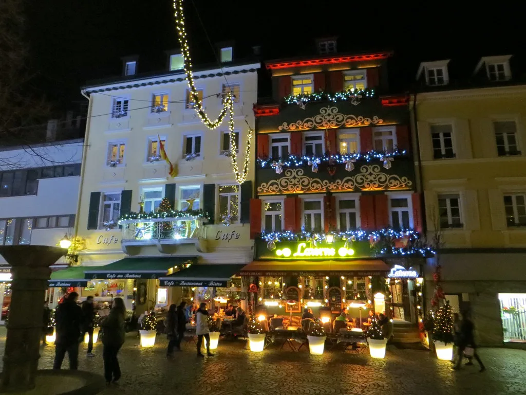 Old-town facades lit with Christmas lights at night, Baden-Baden.