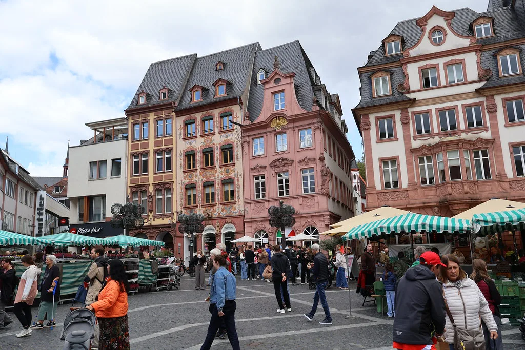 Market stalls in front of historic houses in the old town of Mainz.