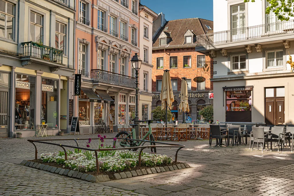 Café tables on a square in Aachen's old town.