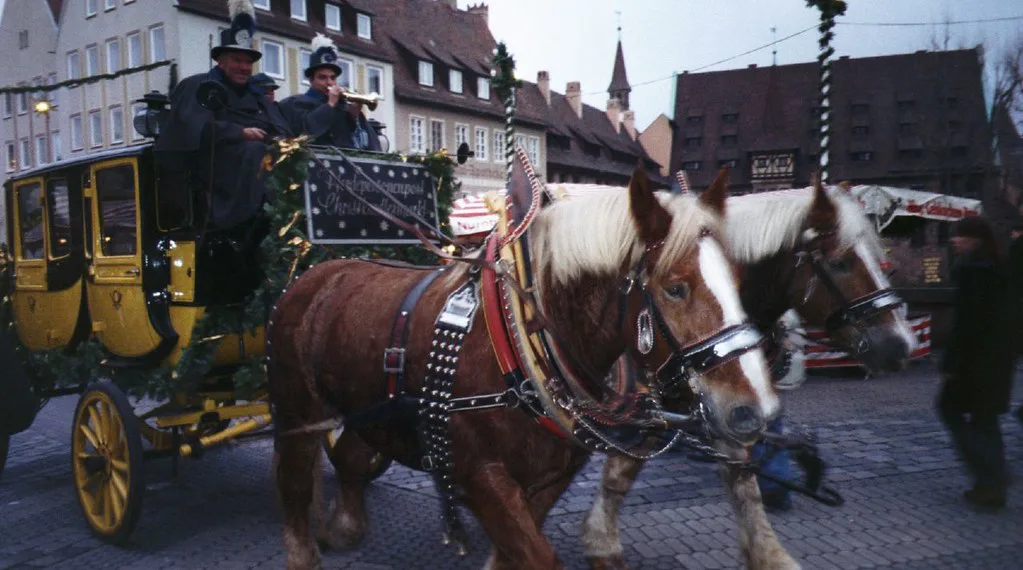 A horse-drawn post coach on the Hauptmarkt during the Christmas season, Nuremberg.