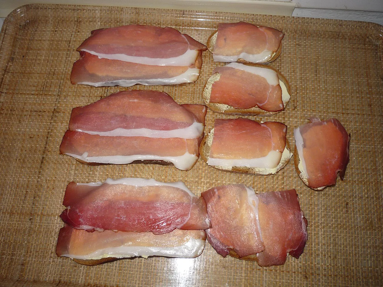 Slices of Black Forest ham on dark bread.
