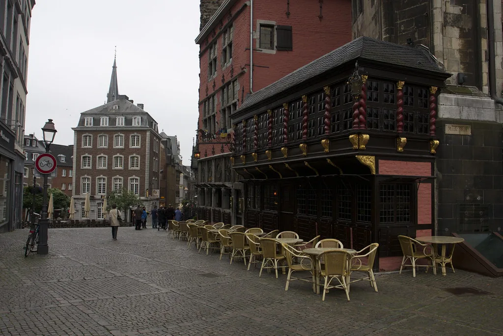 Café tables on a cobbled square in the old town, Aachen.