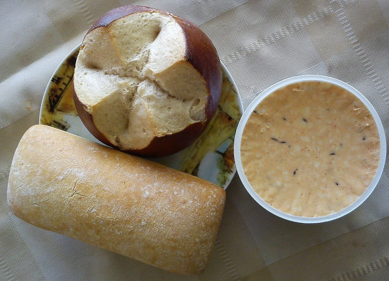 Obazda cheese spread with a pretzel roll and bread.