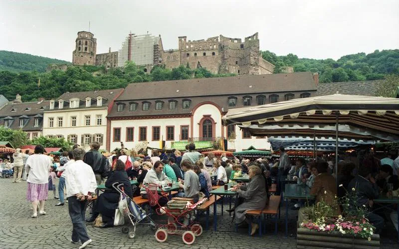 Market stalls on Heidelberg's Marktplatz below the castle, near Café Knösel.