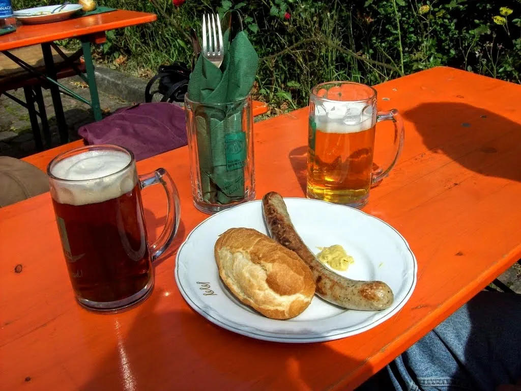 Bratwurst, bread and beer on a garden table at the historic Hirschgasse inn, Heidelberg.