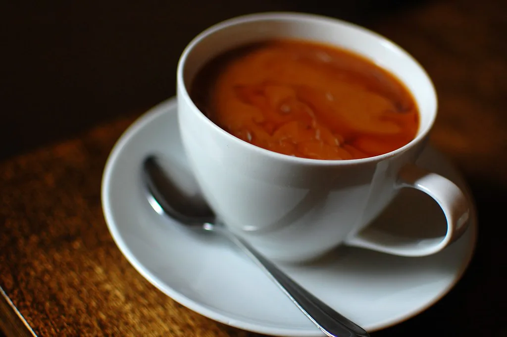 A cup of coffee on a saucer.
