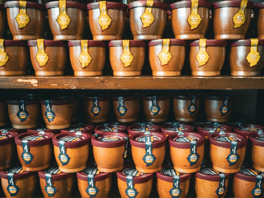 Stacked stoneware pots of Düsseldorf mustard.