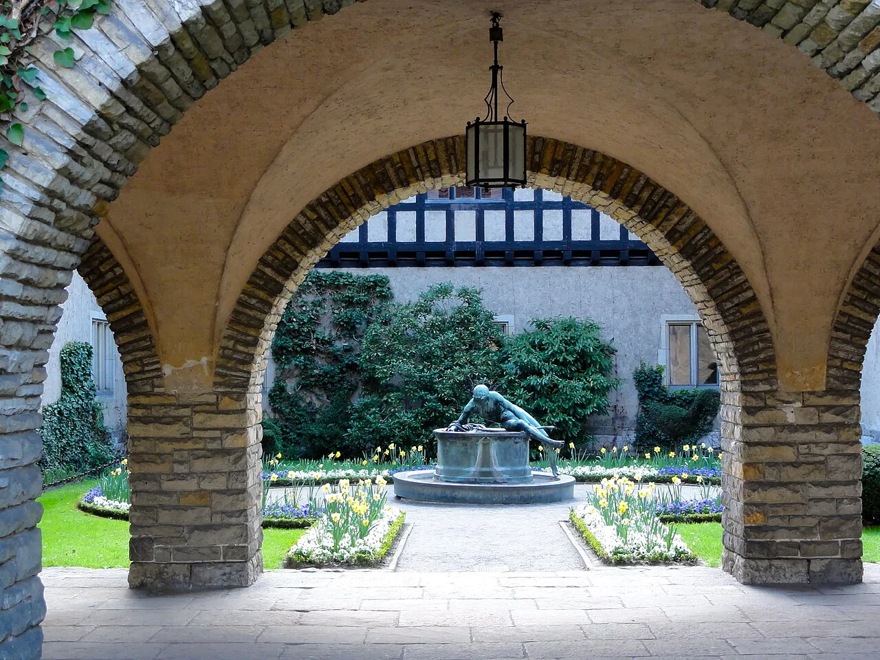 Narcissus Fountain framed by the arches of Cecilienhof Palace, Potsdam.