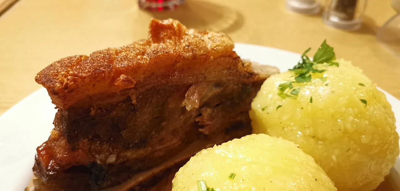 Franconian Schäufele (roast pork shoulder) with potato dumplings and gravy.