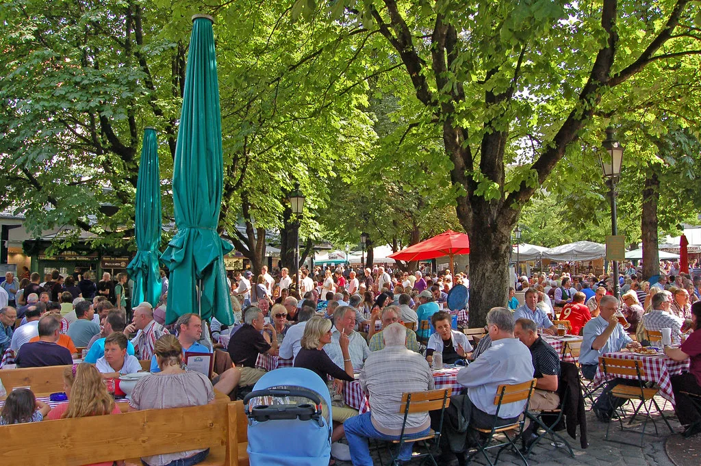 A busy beer garden under chestnut trees at the Viktualienmarkt, Munich.