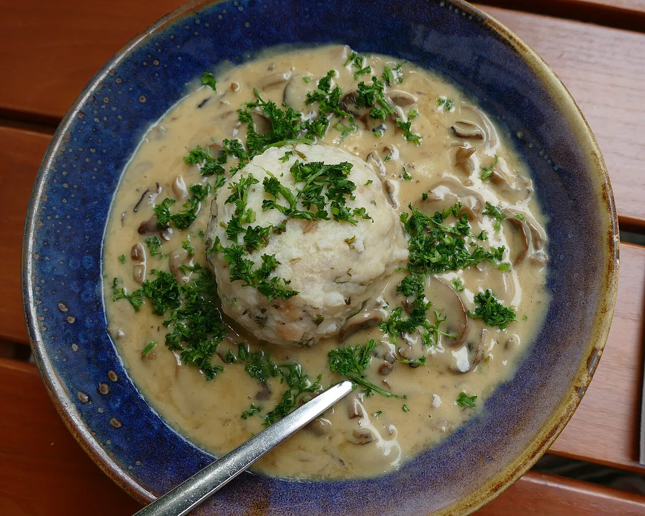 A Bavarian bread dumpling in a creamy mushroom sauce, served in Augsburg.