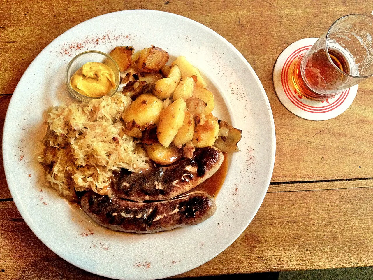 Bratwurst with sauerkraut, fried potatoes, mustard and beer.