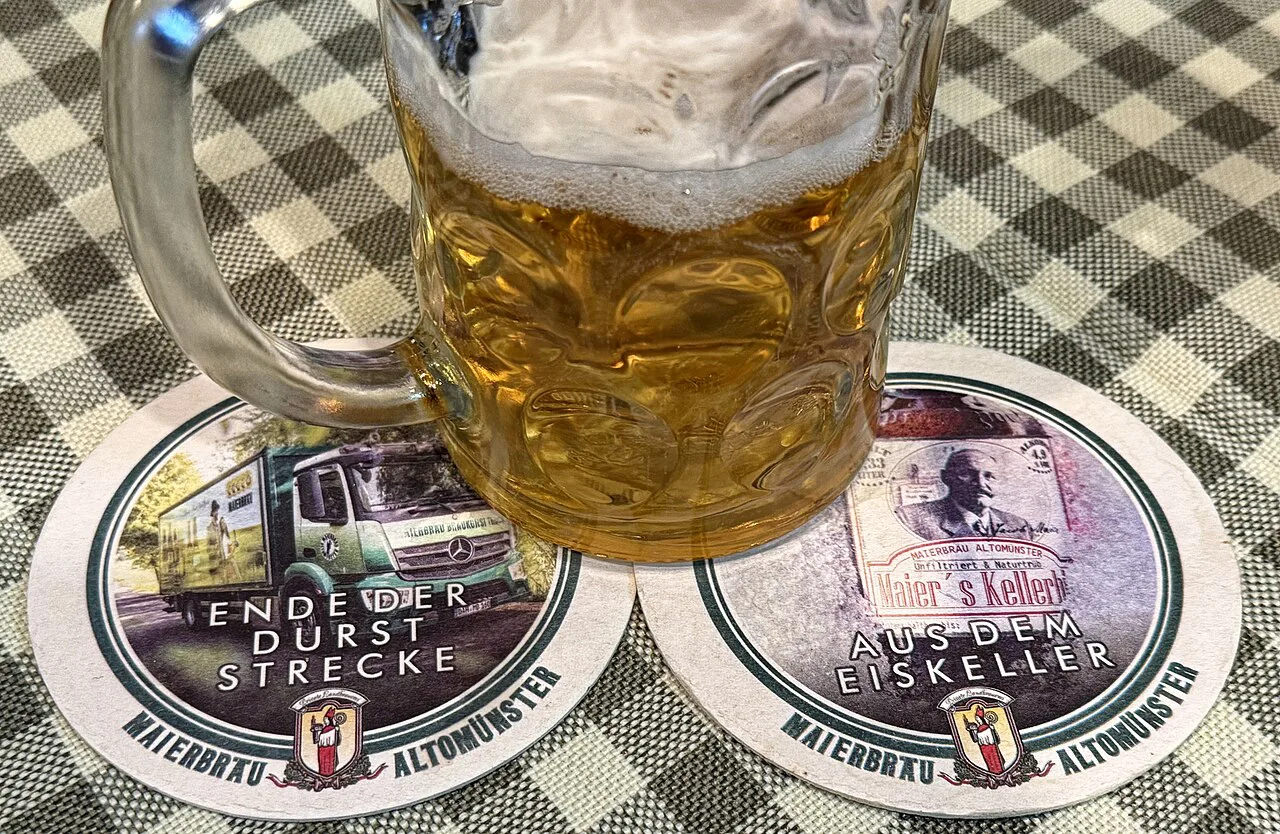 A mug of beer on coasters at the Gasthaus Zum Brünnstein.