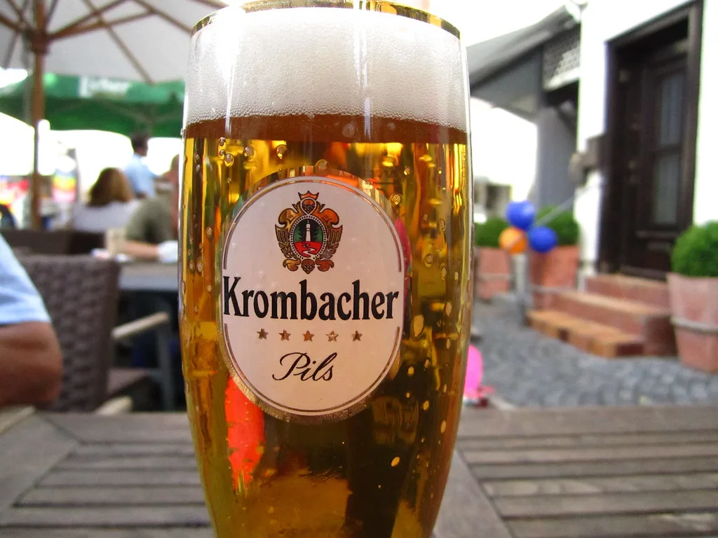 A glass of Krombacher Pils.