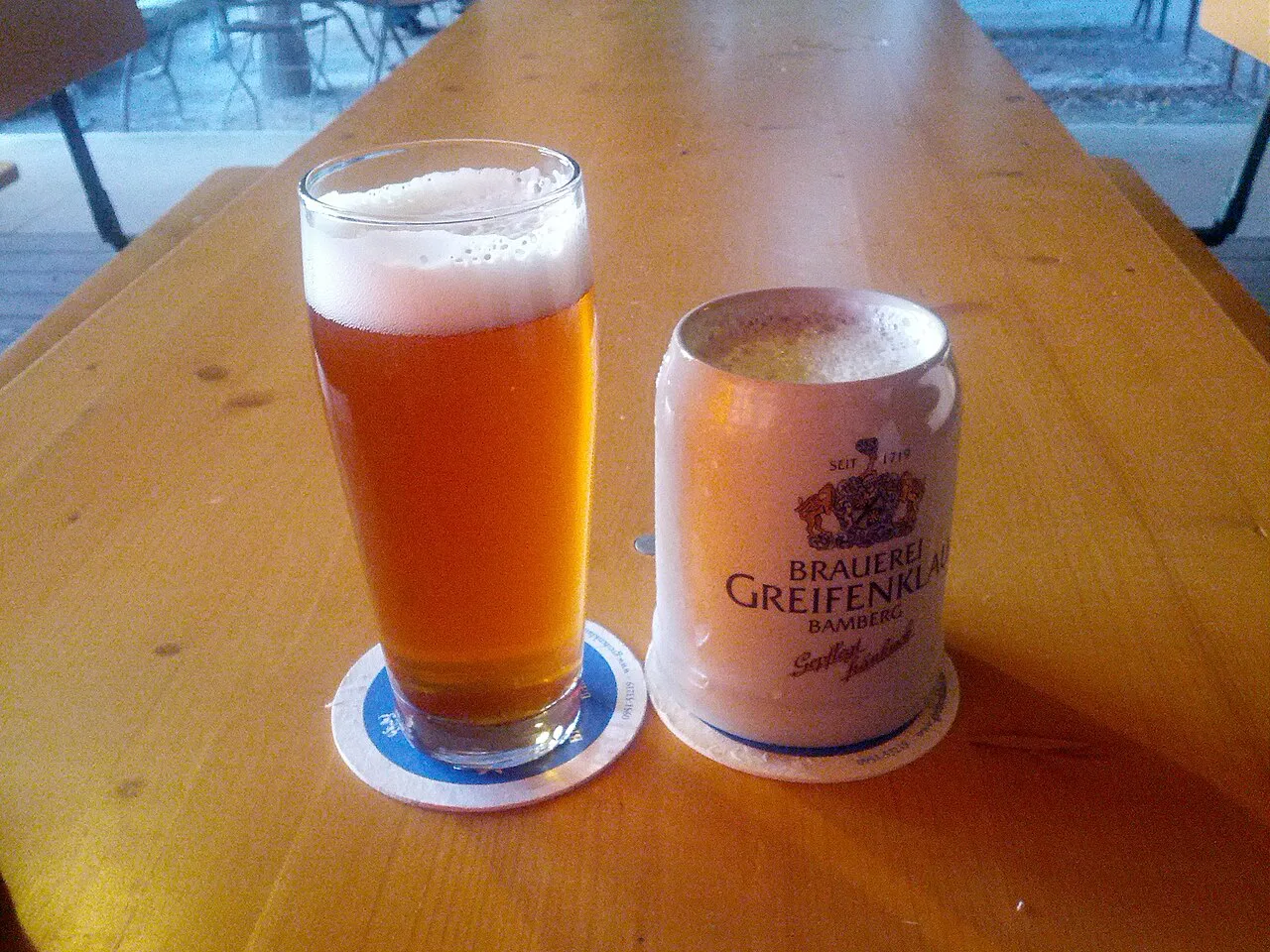 A glass of Greifenklau beer and a Greifenklau mug, Bamberg.