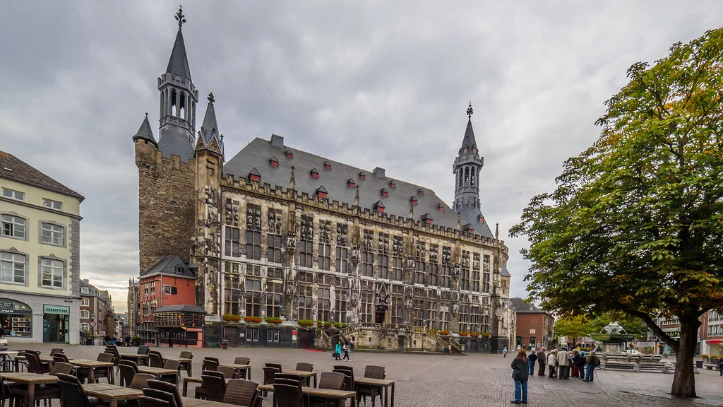 Aachen Town Hall and the Granus Tower above café tables on the Markt, Aachen.