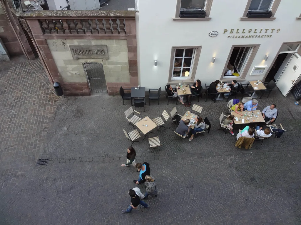 Sidewalk café tables seen from above in Trier.