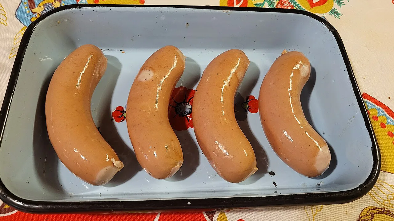 Knackwurst sausages in an enamel dish.