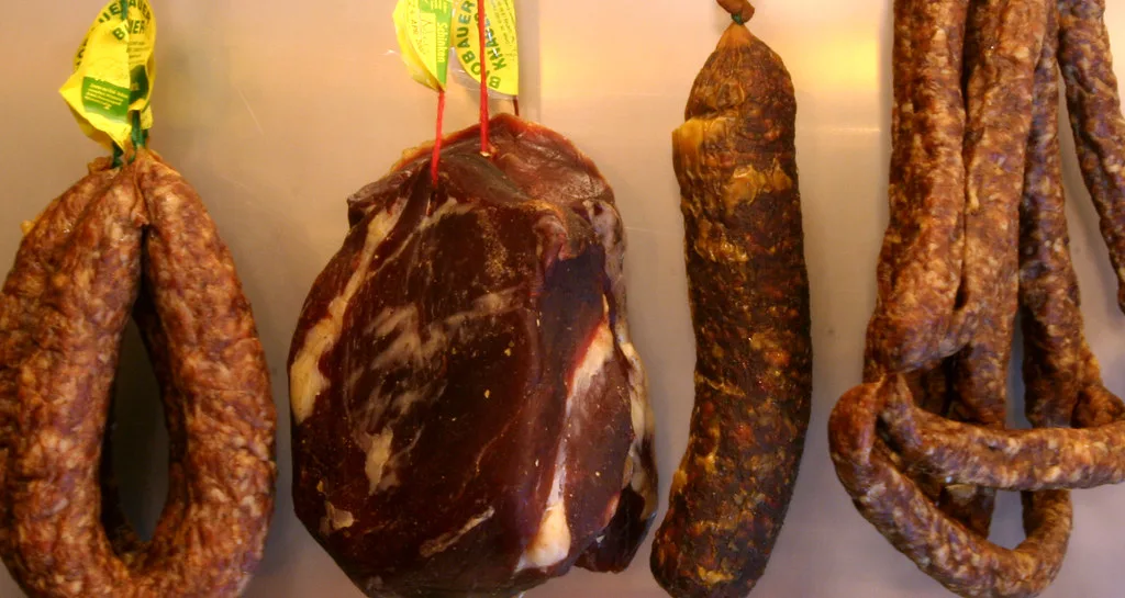 Cured sausages hanging at an organic butcher's shop.