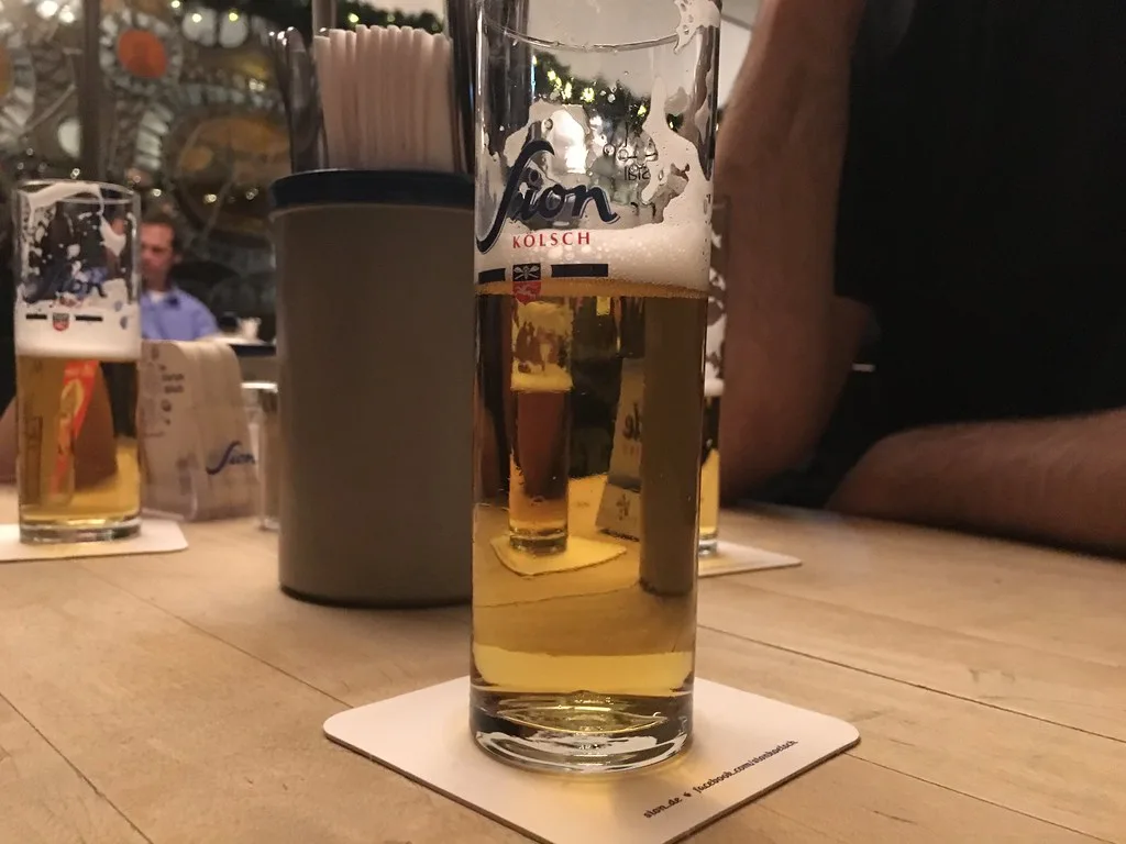 A glass of Kölsch on a beer mat.