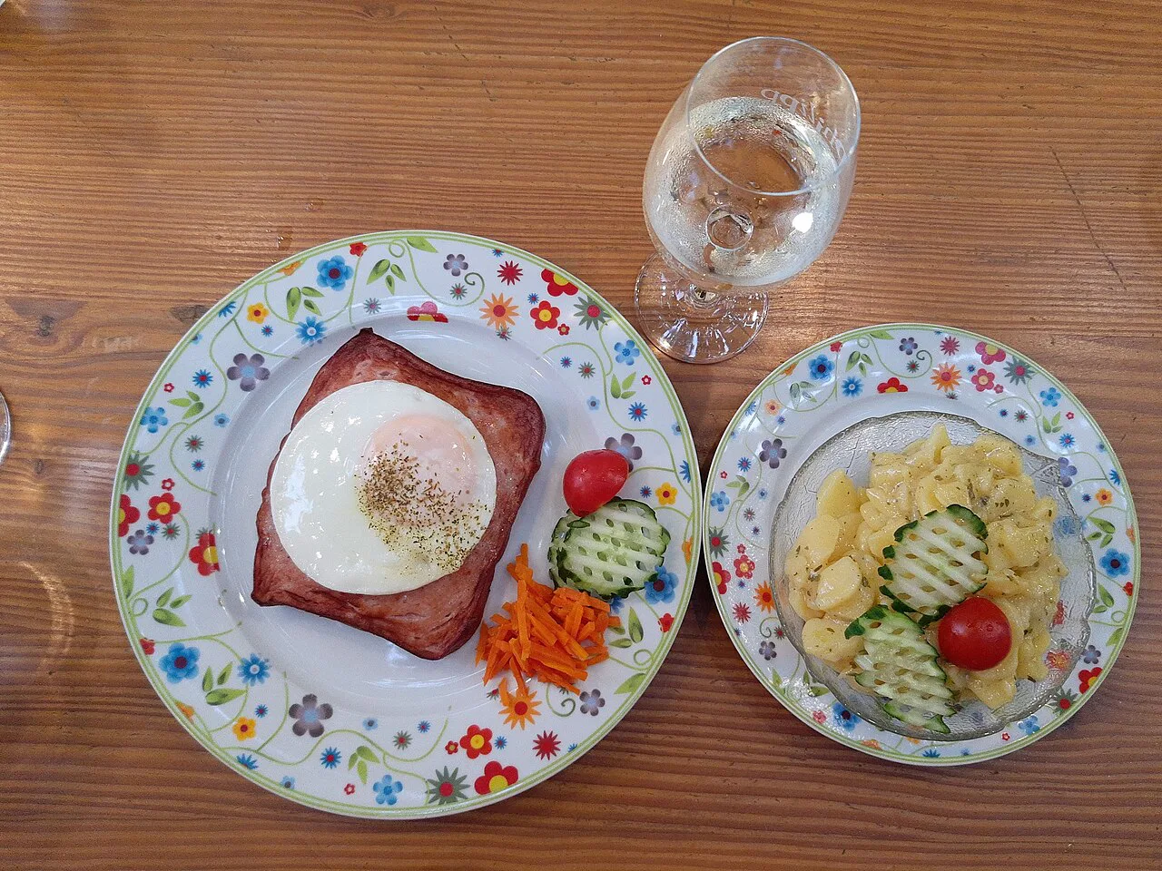 Leberkäse with a fried egg, potato salad and cucumber salad in Rüdesheim.
