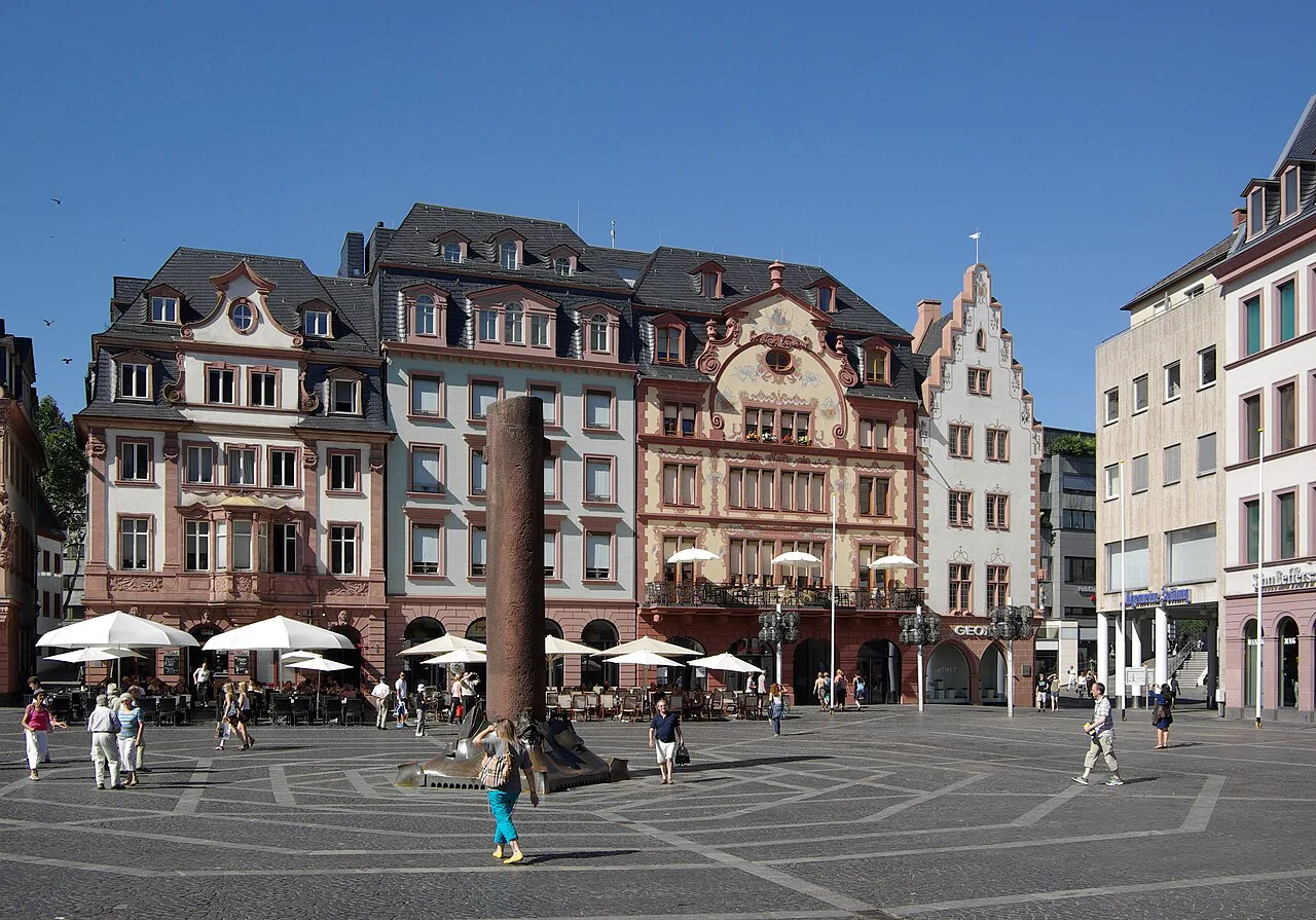 Cafe umbrellas and historic houses on the Markt by the cathedral, Mainz.