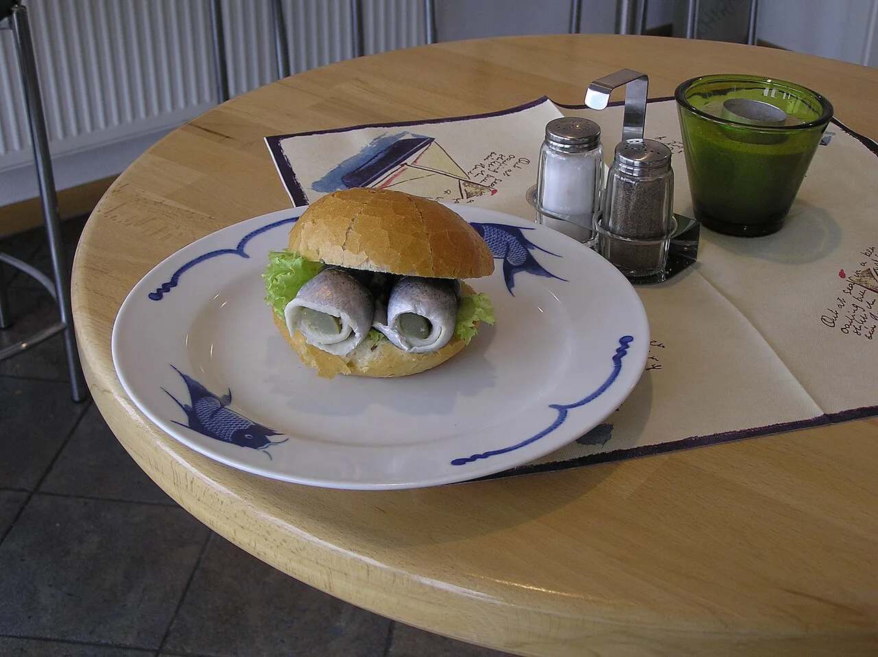 A Fischbrötchen with rolled pickled herring on Nordstrand.
