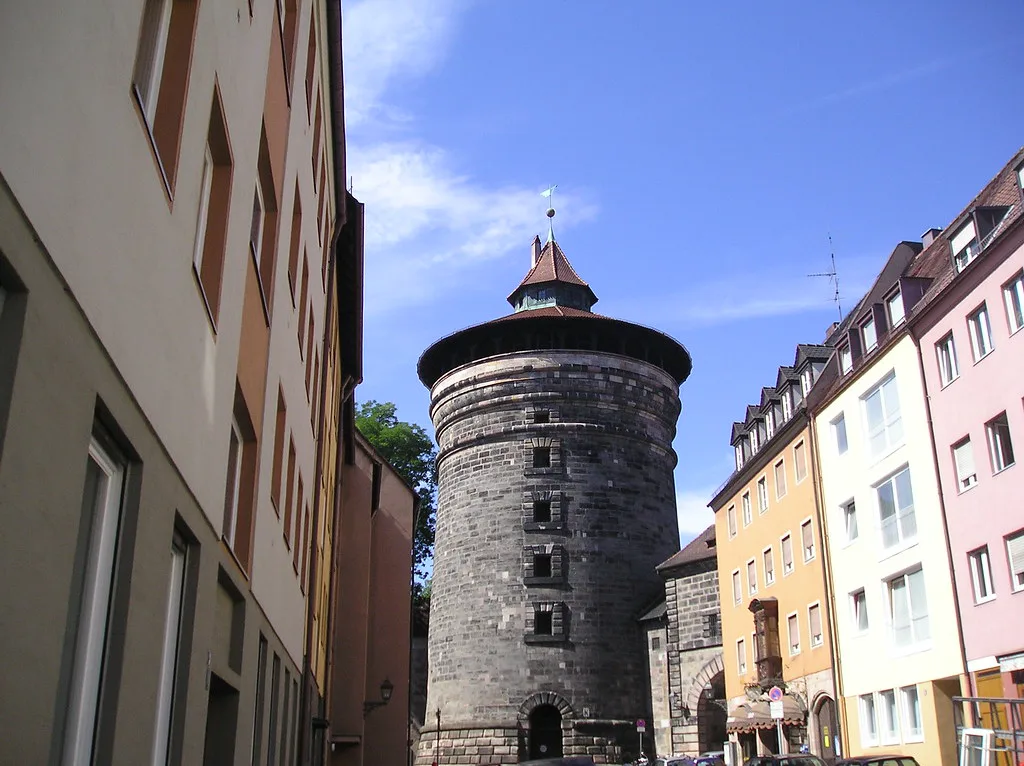 A round medieval city-wall tower among houses, Nuremberg.
