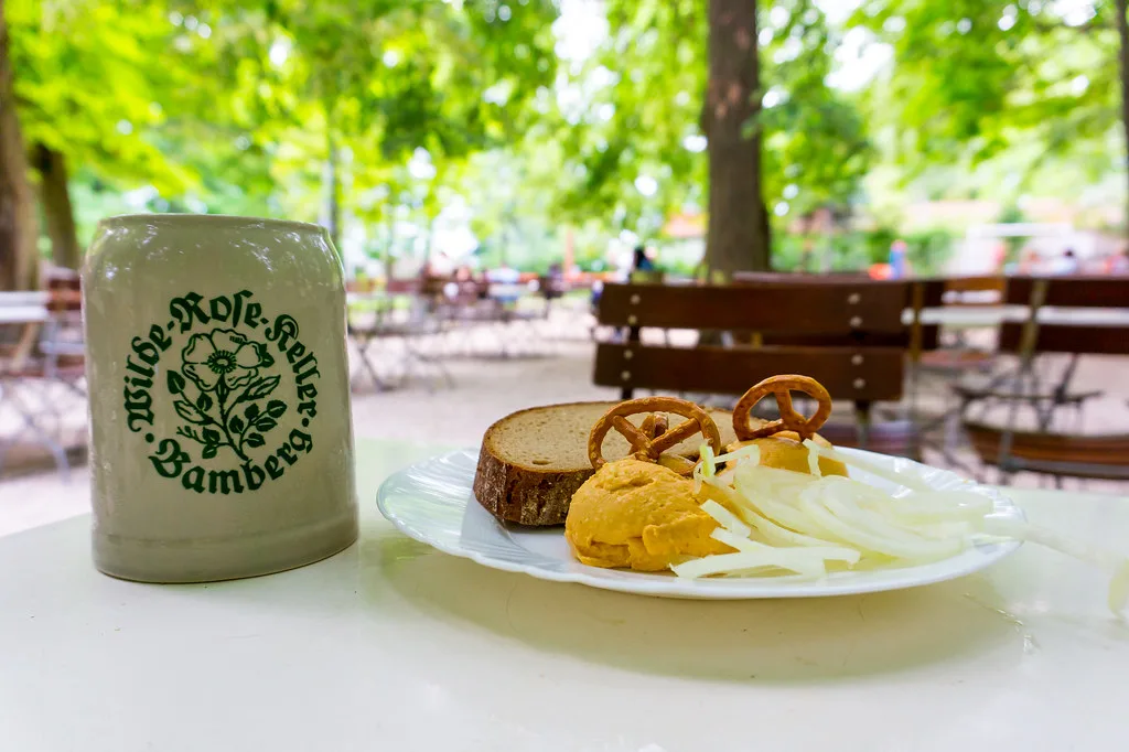 Obatzda with onion rings and a pretzel at the Wilde Rose beer garden, Bamberg.