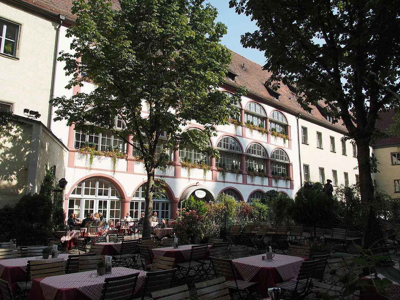 Tables in the Bischofshof courtyard beer garden, Regensburg.