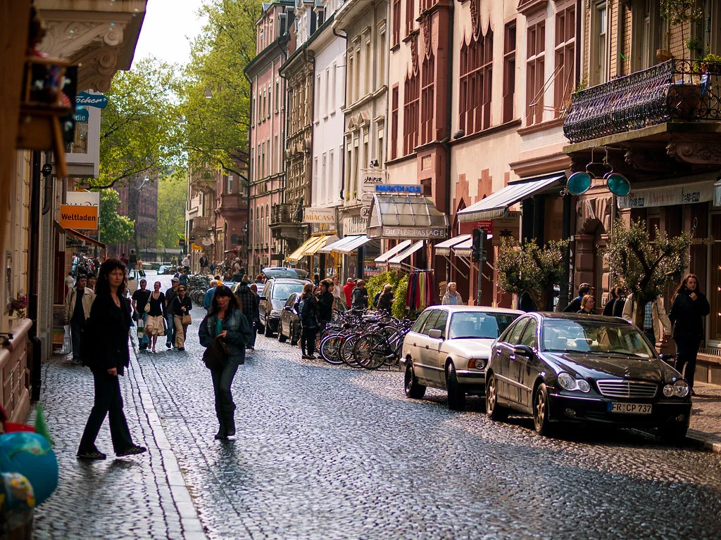 A cobbled old-town street with shops, Freiburg.
