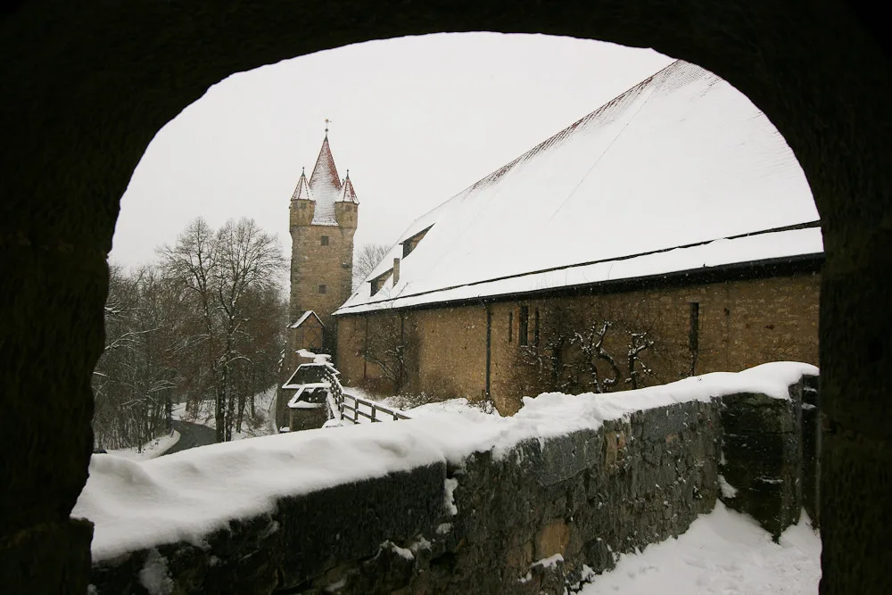 The snow-covered city wall and a tower, Rothenburg ob der Tauber.