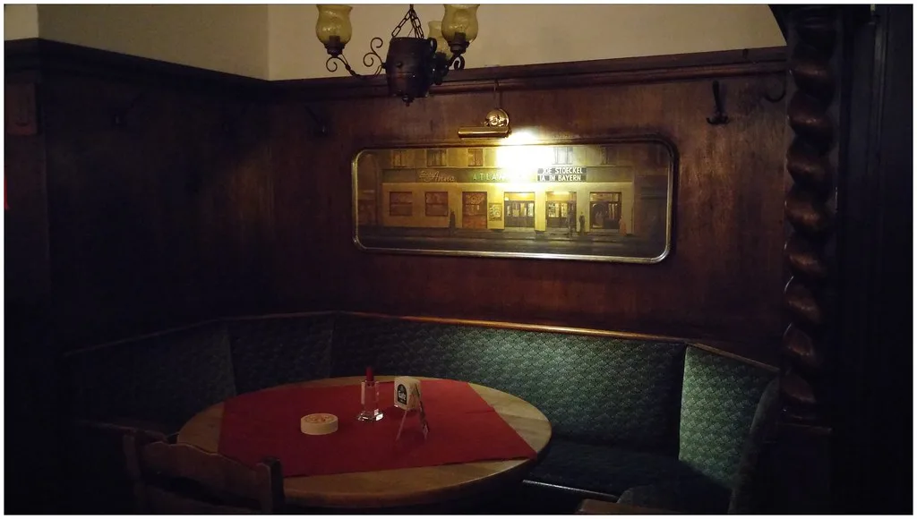 A wood-paneled corner booth in a traditional pub in Düsseldorf-Holthausen.
