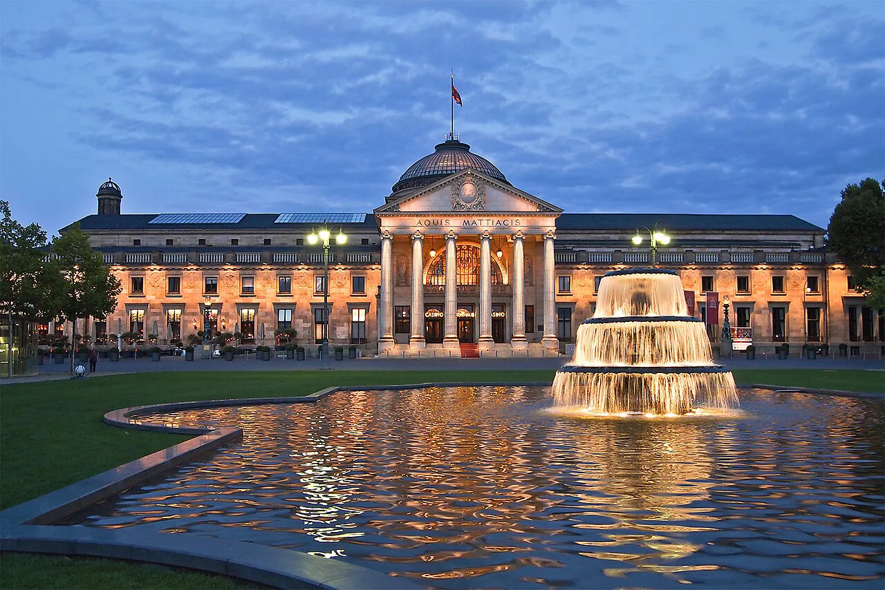 The Kurhaus and its Bowling Green fountain at dusk, Wiesbaden.