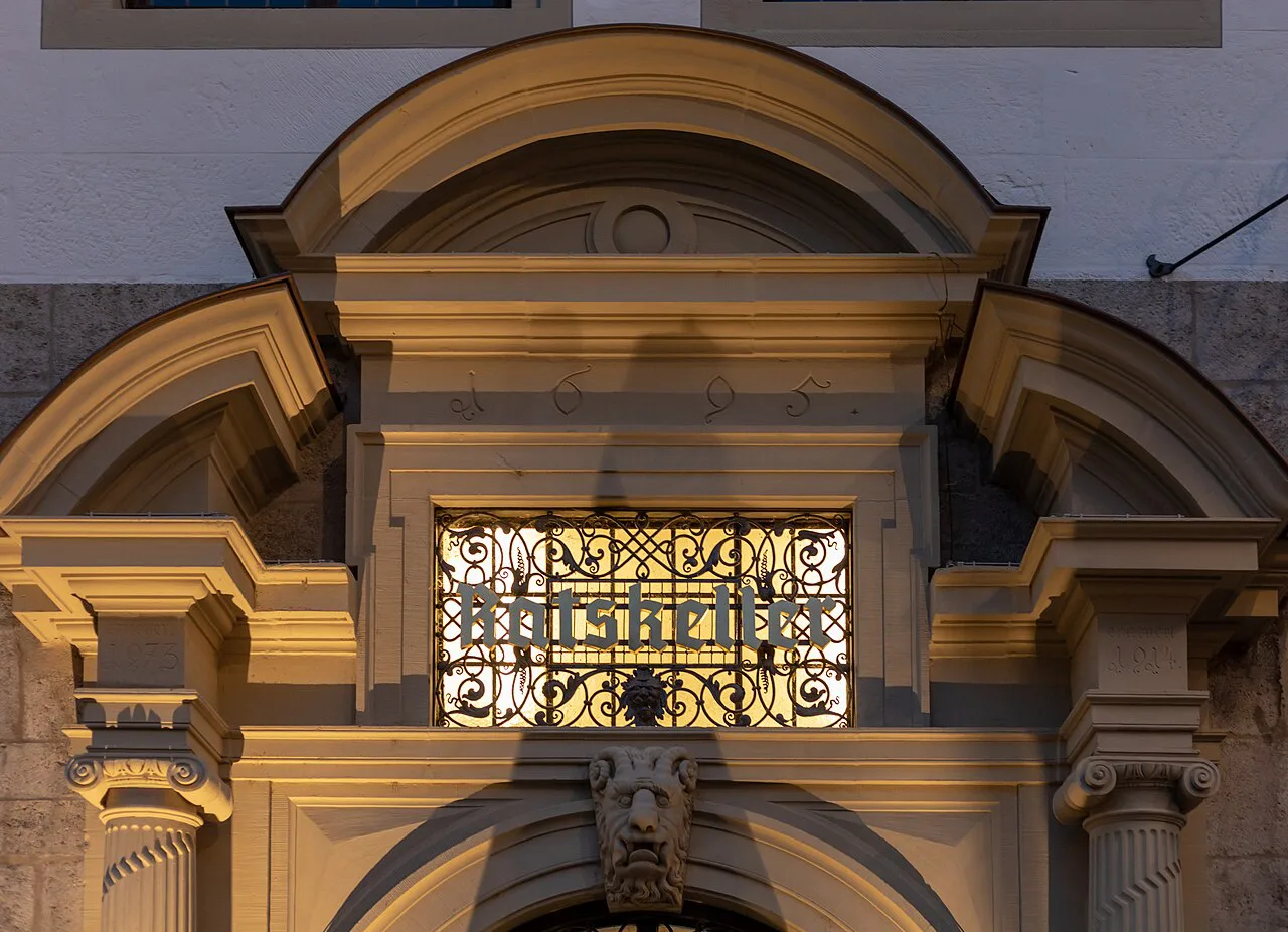 Entrance to the Ratskeller in Würzburg's town hall at dusk.