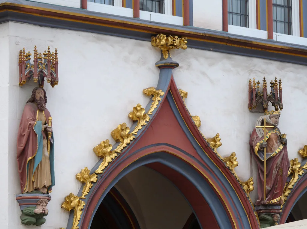 A carved Gothic doorway with painted saint statues in Trier.