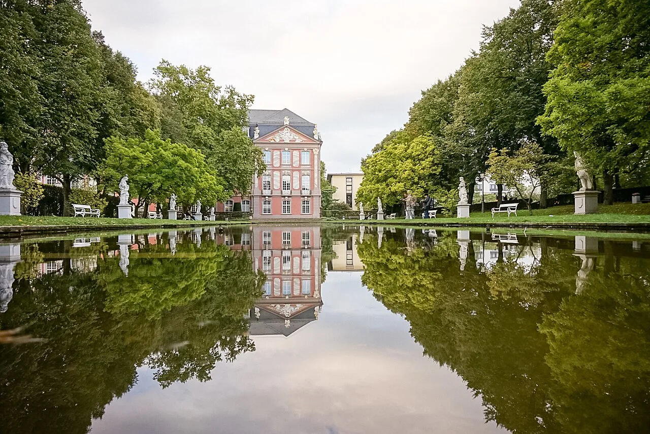 The Electoral Palace reflected in the palace garden pool, Trier.