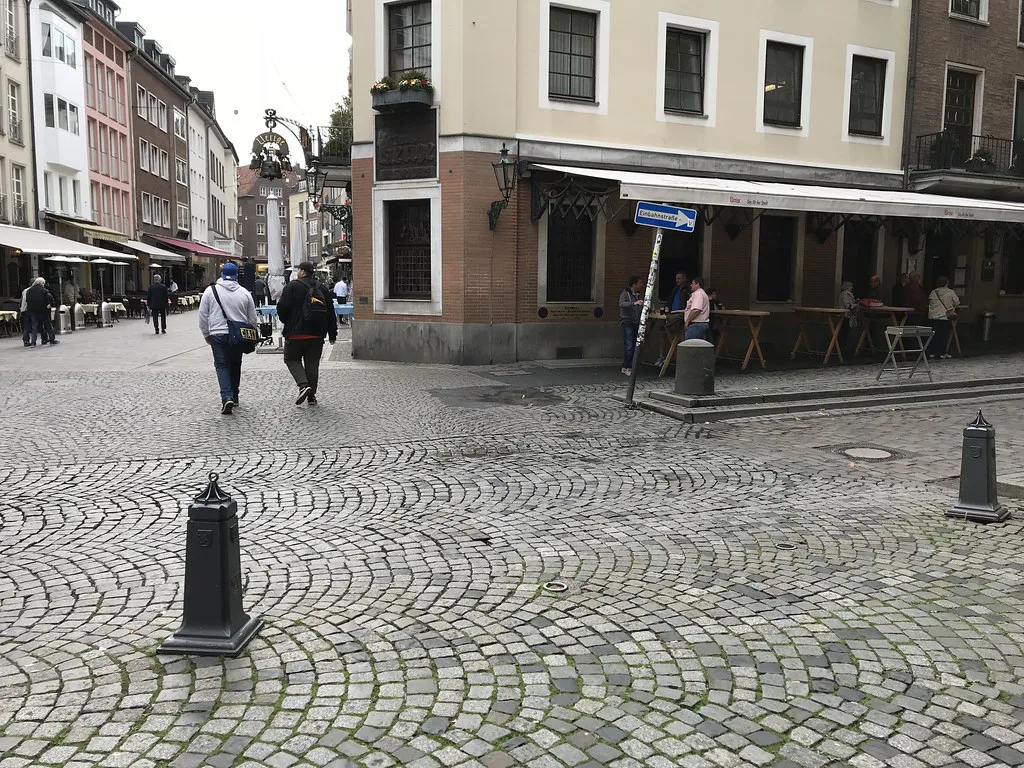 Cobbled Berger Strasse with outdoor tables near the Uerige brewery, Düsseldorf.