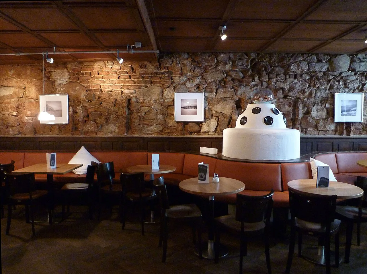 Dining room with an original stone wall at Gasthaus zur Krone, Ulm.