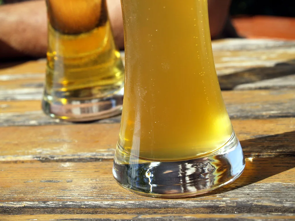 A tall glass of cloudy weissbier.