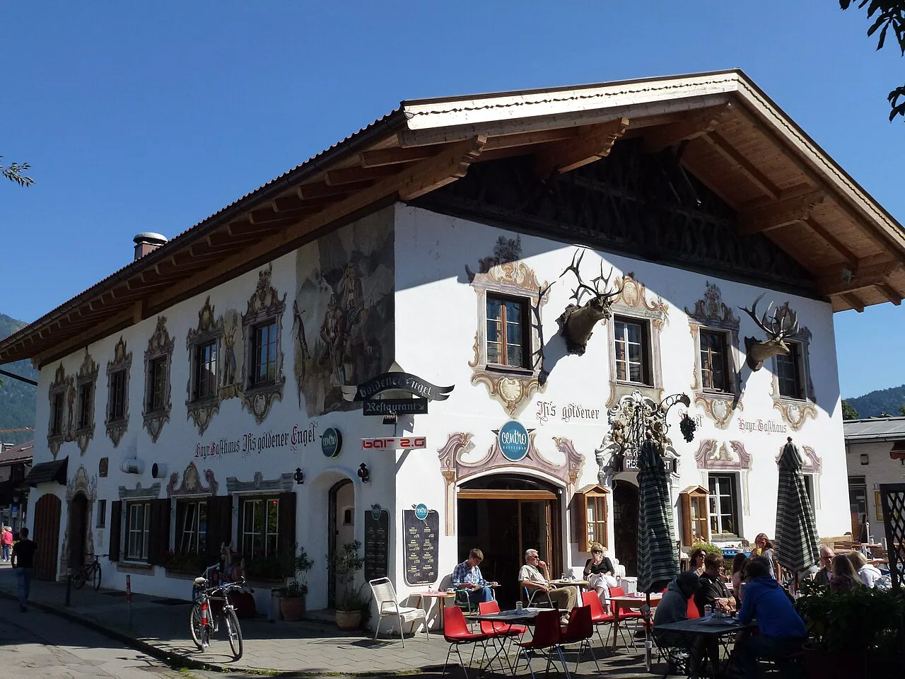Outdoor tables at the painted Gasthaus Goldener Engel on Bankgasse, Garmisch-Partenkirchen.