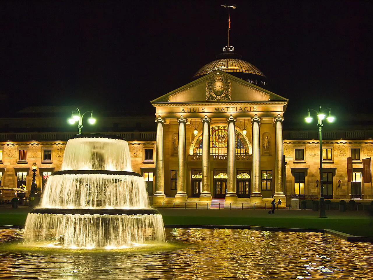 The Kurhaus Wiesbaden and a Bowling Green fountain lit up in the evening, Wiesbaden.