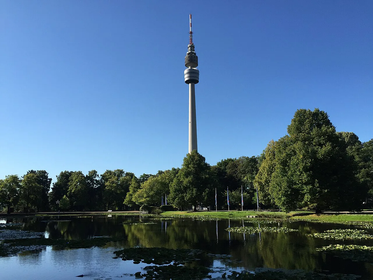 The Florianturm TV tower above a pond in Westfalenpark, Dortmund.